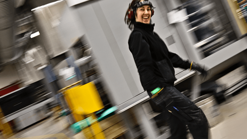 Smiling women walking in a manufacutring facility