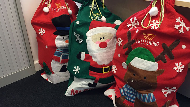 Three Trelleborg Christmas bags with snowman, Santa and reindeer offered to children hospital charity
