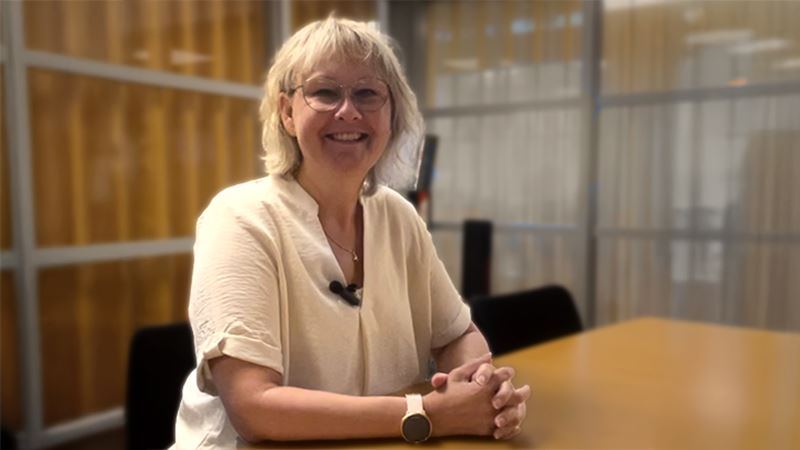 Christina Håkansson smiling in a conference room