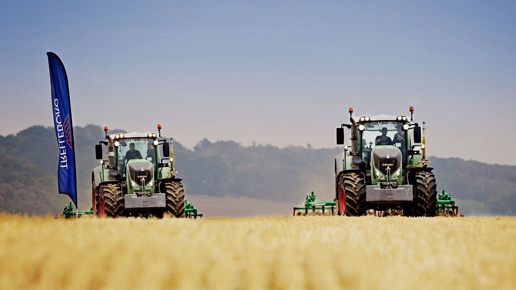 Two tractors in field with Trelleborg flag