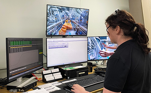 Beth Jordan looking at multiple computer screens