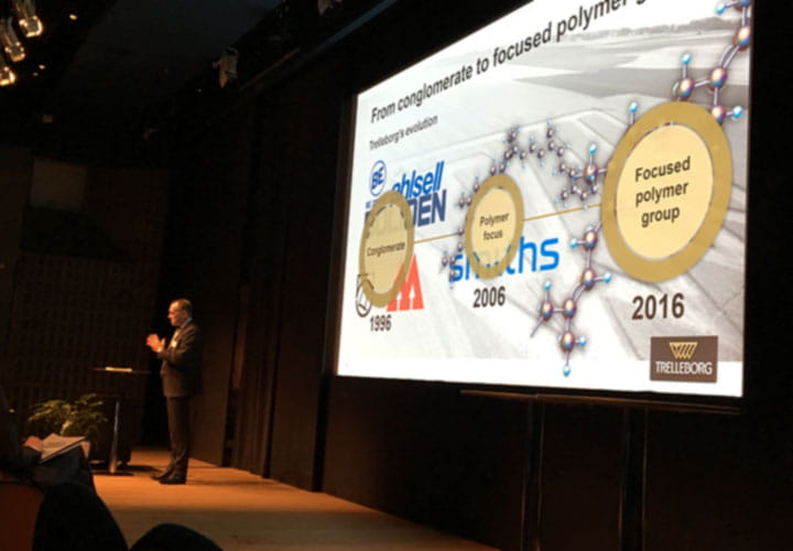 Peter Nilsson on the stage holding a presentaton