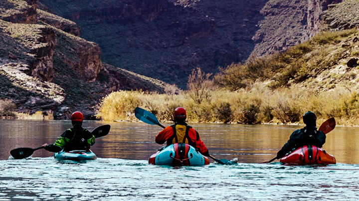 Three people rafting in Grand Canyon