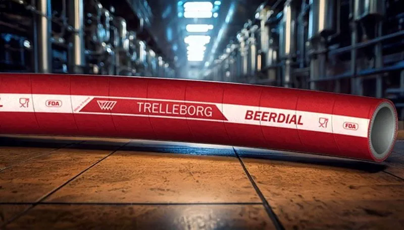 Trelleborg BEERDIAL industrial hose with FDA markings, lying on a tiled floor in a brewery