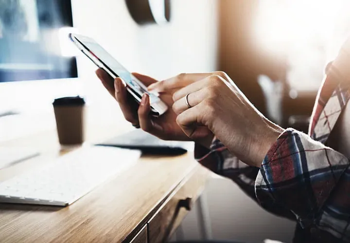 Hand using smartphone for Trelleborg subscriptions