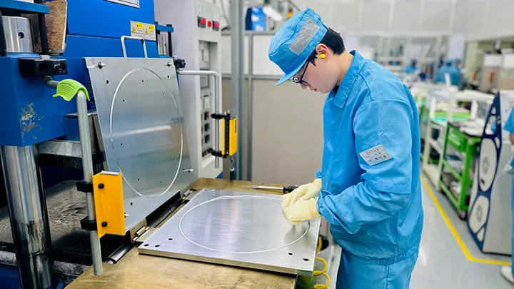 Man working with O-ring molding in a clean room