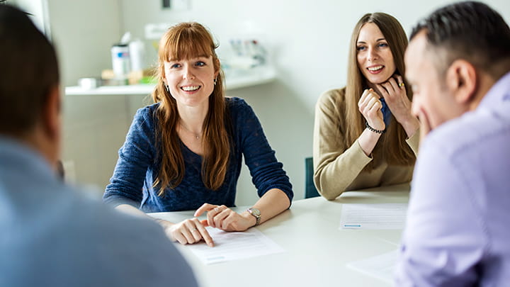 Happy people around a table