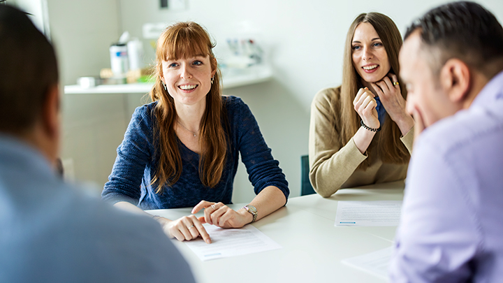 Happy people around a table