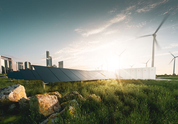 Green sustainable energy produced next to city with solar panels farm in nature and wind turbines in background