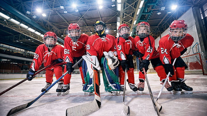 Six children playing ice hockey in same team