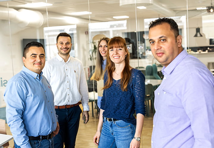 Colleagues smiling at Trelleborg HQ, showcasing teamwork, positivity, and community empowerment.