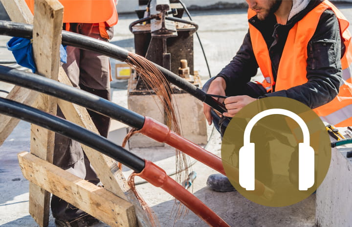 An Operator manipulating cables with a headphone icon as overlay