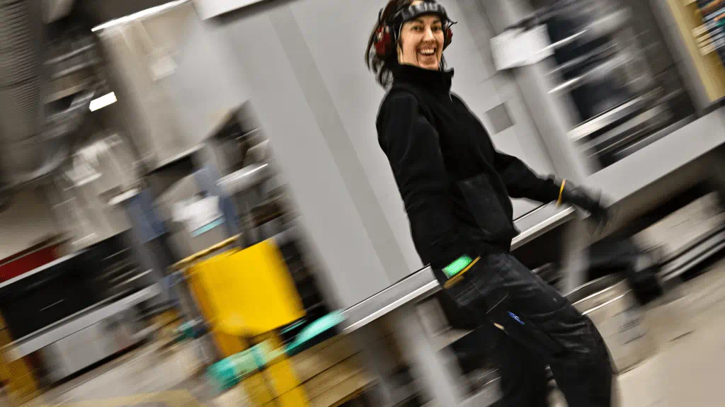 Smiling women walking in a manufacutring facility