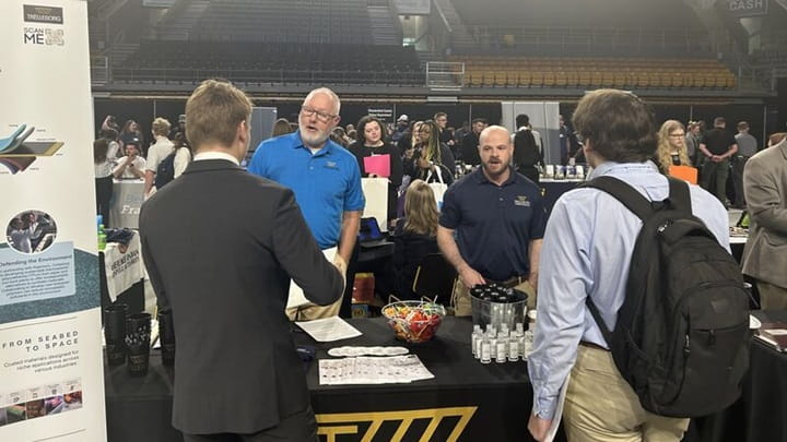  Employees talking to students at career fair
