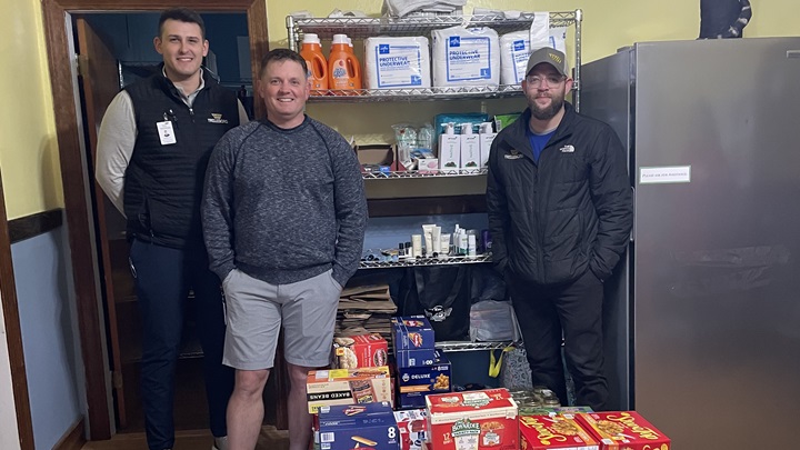 Employees donating food to food pantry