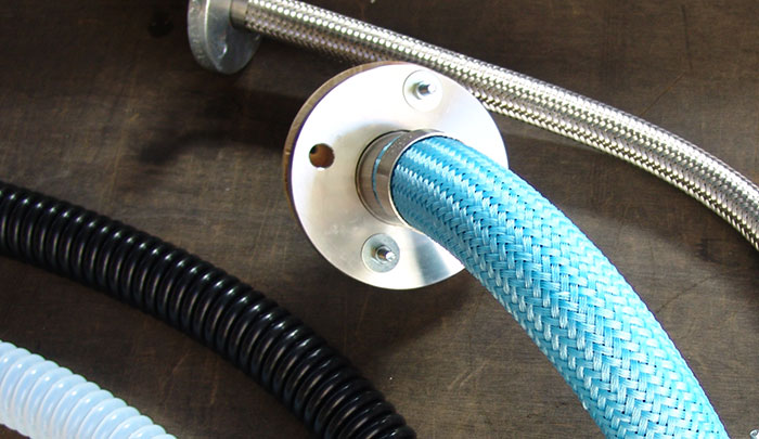 Convoluted PTFE hose assemblies for transfer of aggressive and corrosive chemicals.