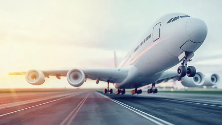 Commercial aircraft on a runway during takeoff or landing, viewed from a low angle