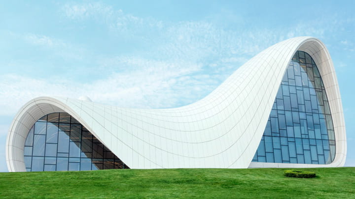 Modern building with curved white structure and large glass doors