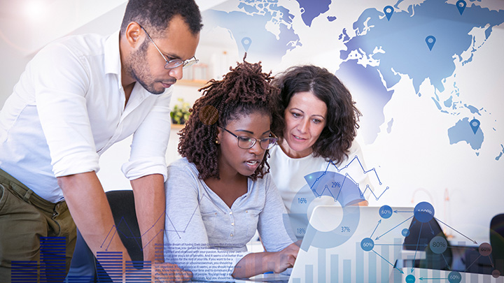 Team collaborating with global map and data charts overlay, representing worldwide capabilities