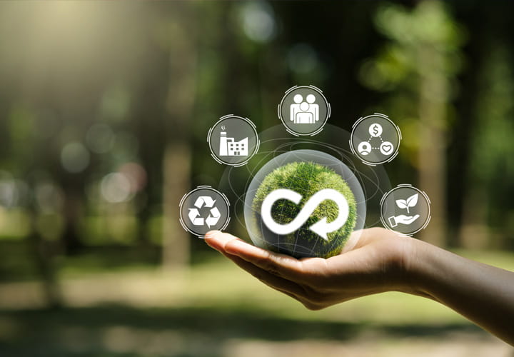 Hand holding a green sphere with an infinity symbol, representing sustainable circular sealing profiles with recycling and efficiency icons in a natural setting