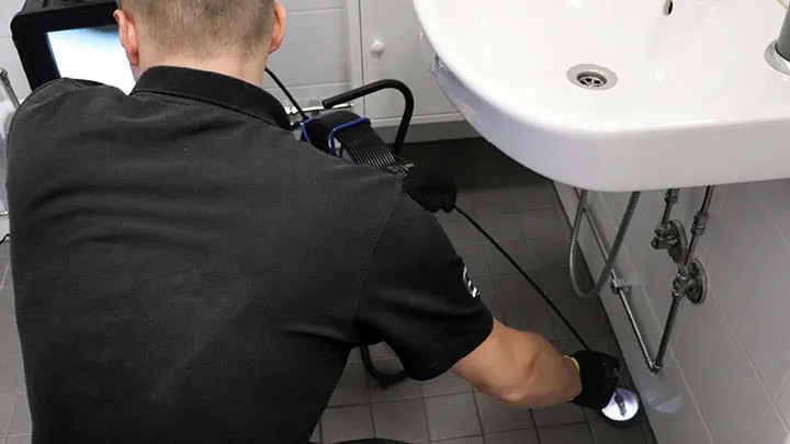 An operator conducting pipe rehabilitation using the Trelleborg Spraypoxy system