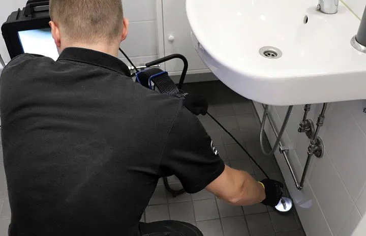 An operator conducting pipe rehabilitation using the Trelleborg Spraypoxy system