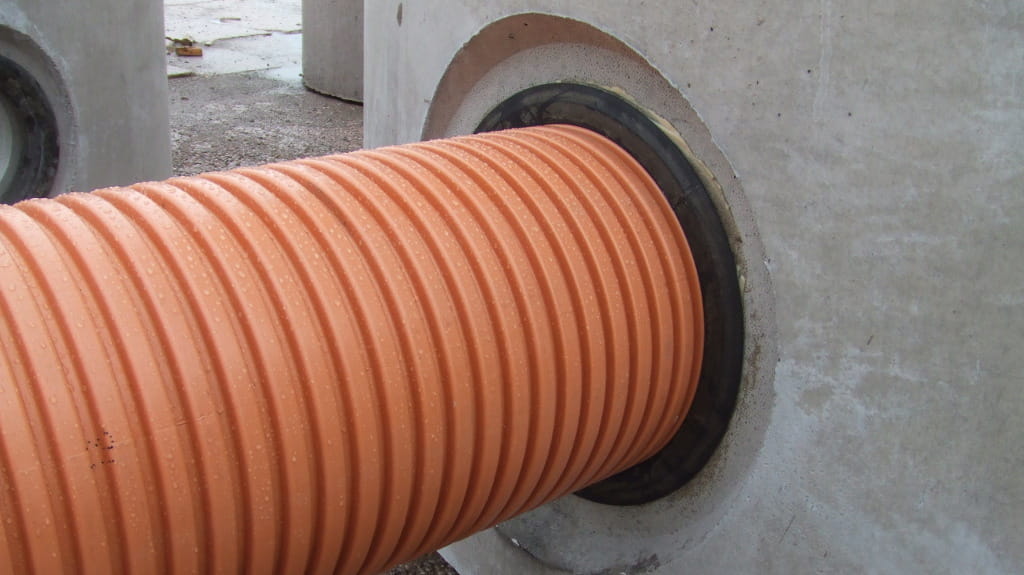 Orange corrugated pipe in a manhole