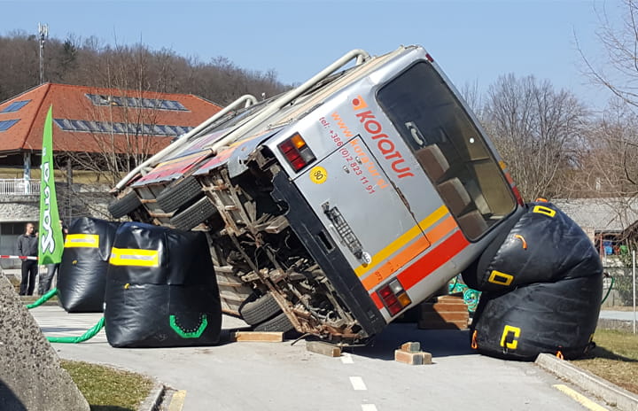 A bus lying in a large catch bag, used for rescue purposes