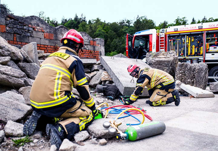 Two firefighters using lifting bags to rescue a person during an emergency drill