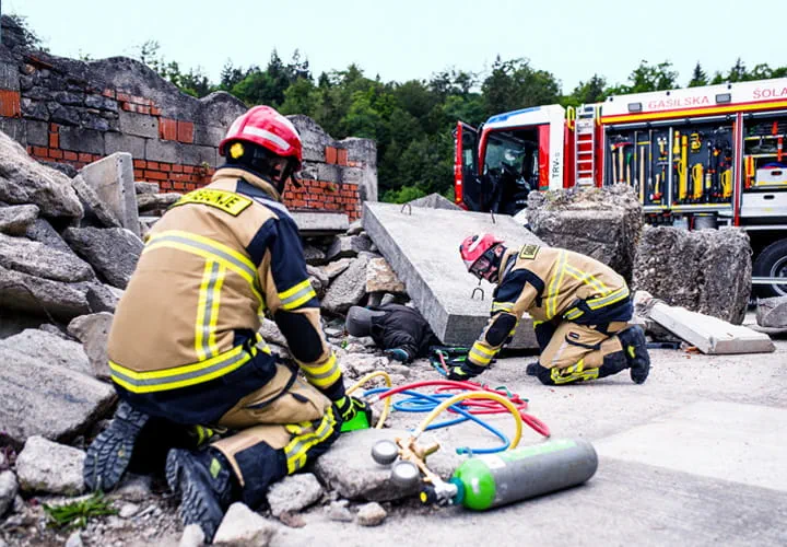 Two firefighters using lifting bags to rescue a person during an emergency drill
