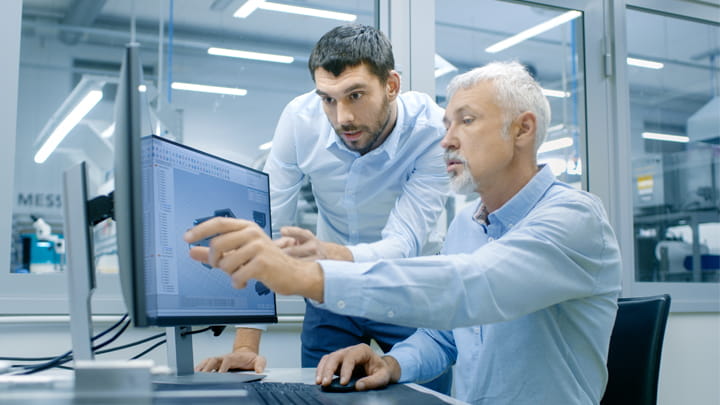 Two guys looking at the screen