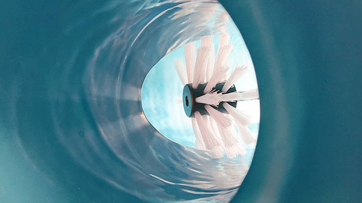 Close-up view of a rehabilitated pipe interior, clearly showing the smooth, uniform coating applied by the Spraypoxy system. 