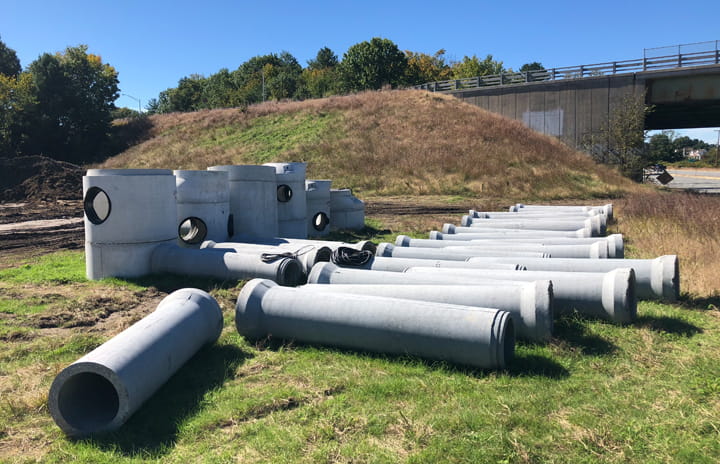 Concrete pipes and manholes on the field