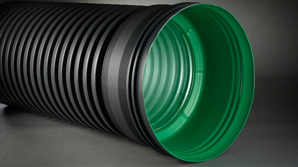 Green and black corrugated pipe