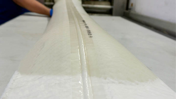Liner laid out on a table, prepared for lateral pipe rehabilitation 